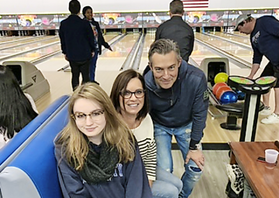 people smiling at bowling alley