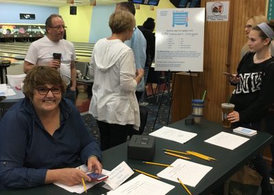 people at sign-in table at fundraiser